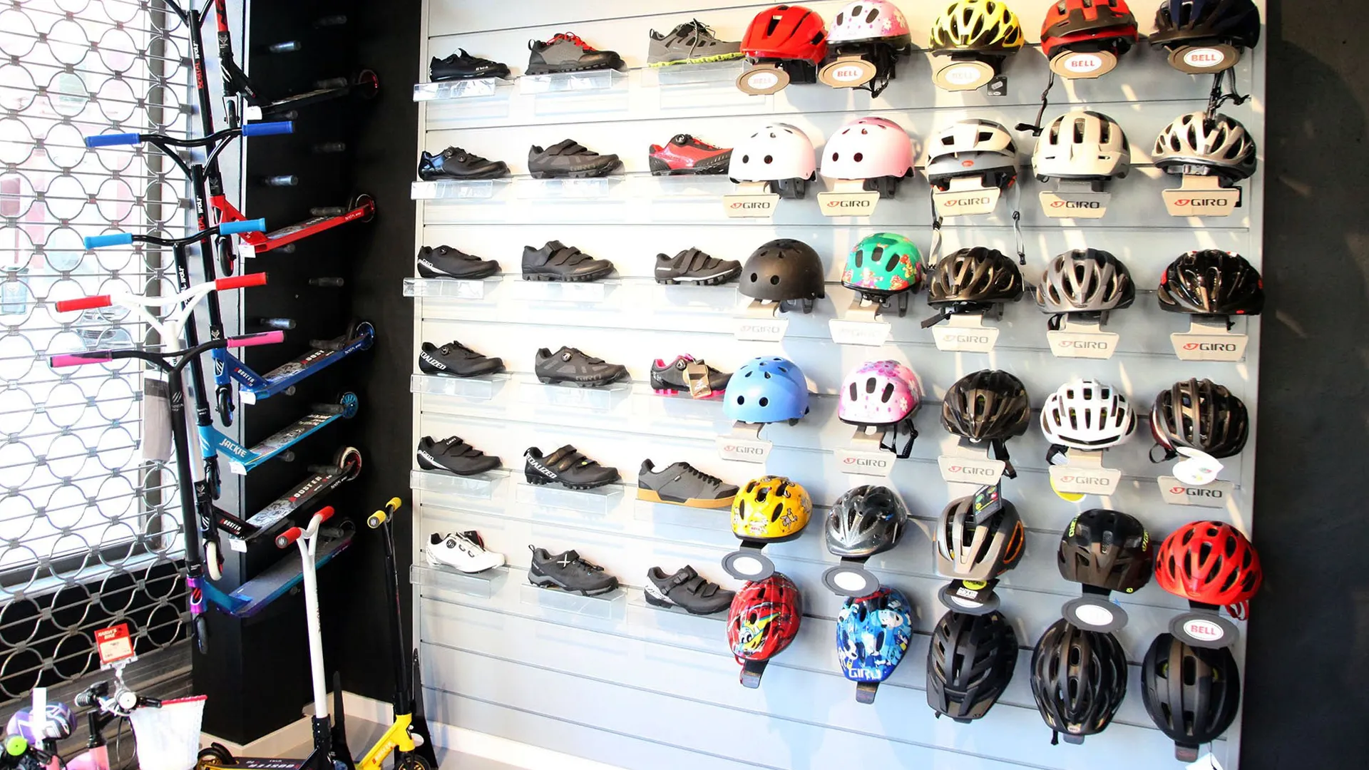Helmet fitting and certification guide showing a store wall filled with different helmets