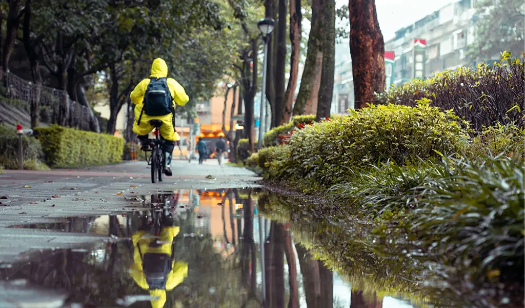 Man dressed after the weather he is biking in